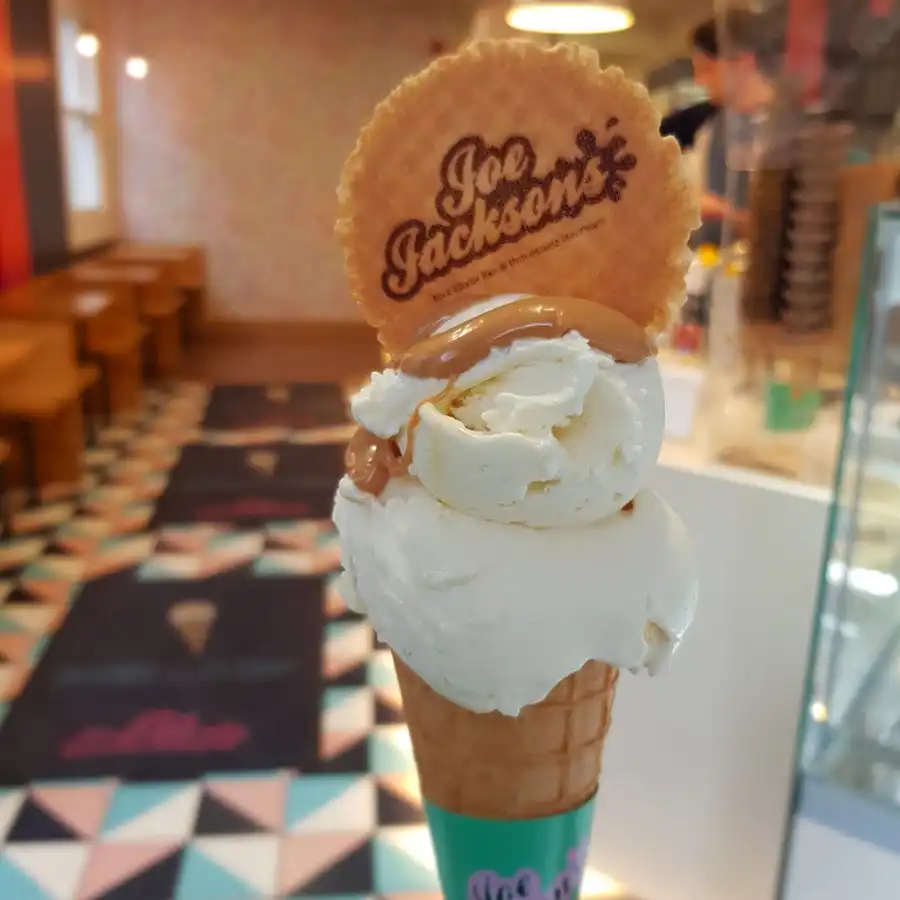 Milkybar ice cream in a cone with caramel sauce and a wafer with joe jackson name on it